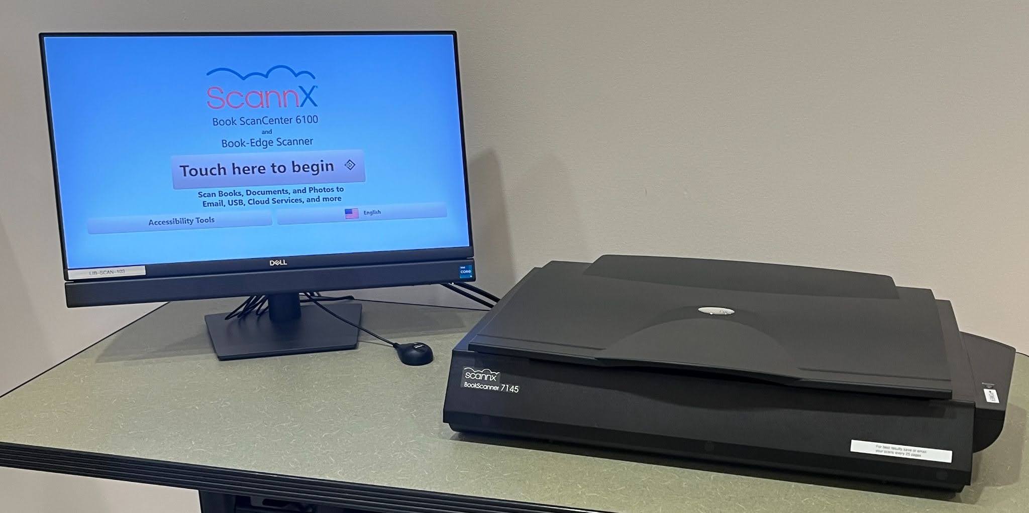 A large, flatbed scanner with a touchscreen display showing a welcome message and instructions to begin scanning.